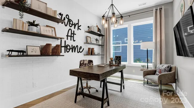 a view of a livingroom with furniture and a window