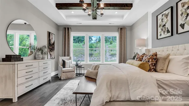 a bed room with a bed and a chandelier