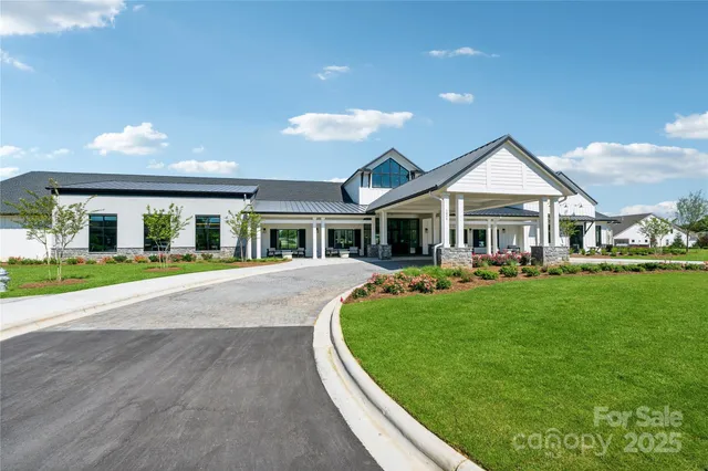 a front view of house with a garden and swimming pool