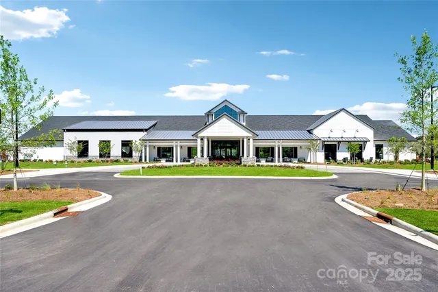 a large kitchen with kitchen island a large window and cabinets