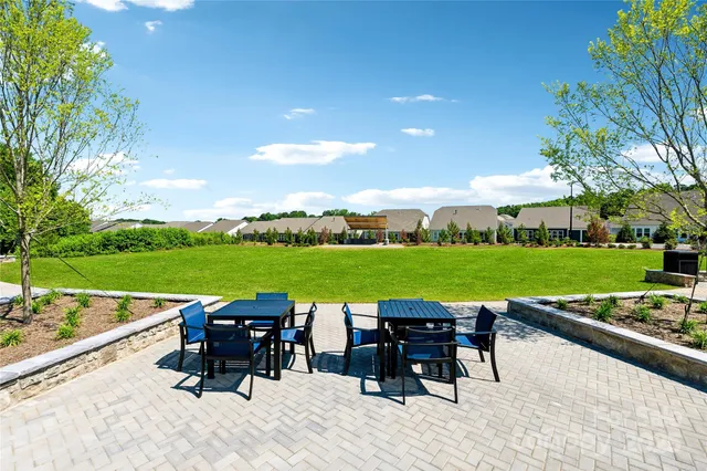 a front view of a house with a yard and dining table