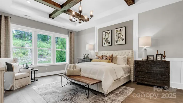 a bedroom with a bed couches and window