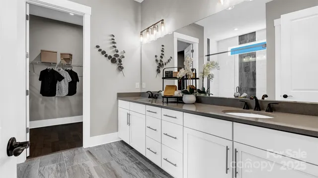 a spacious bathroom with a double vanity sink and a mirror