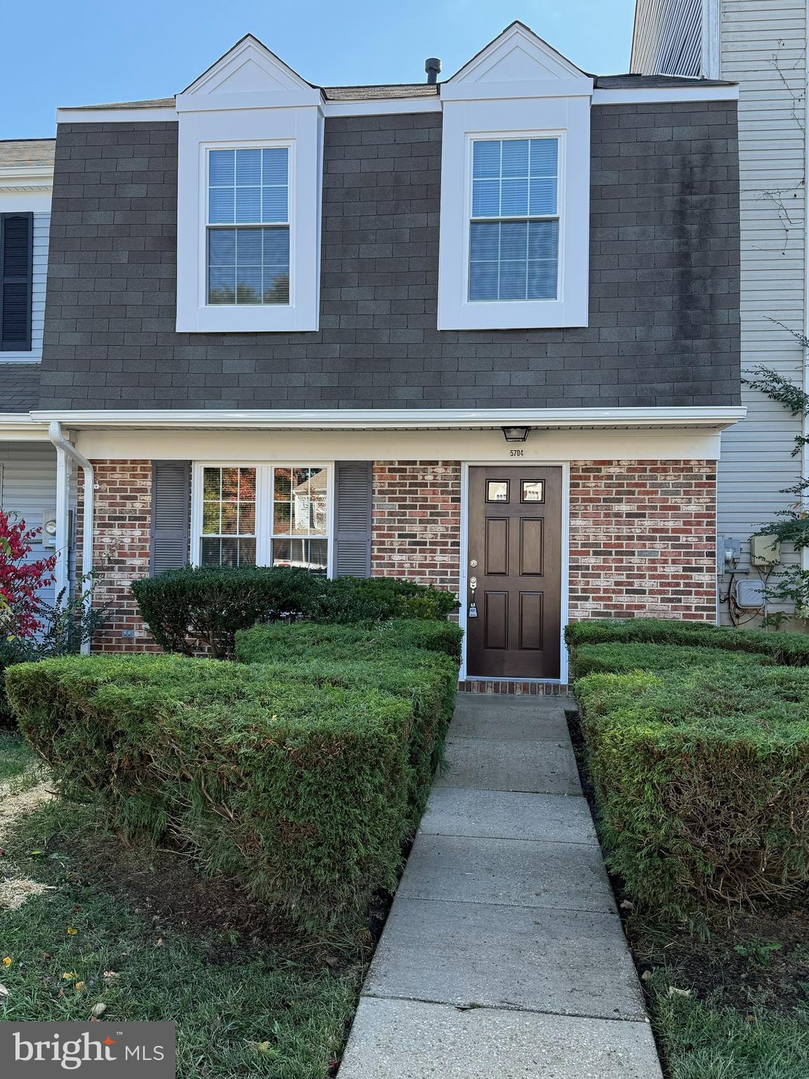 5704 Springfish Place Waldorf, MD 20603 - Photo 1 of 38 a view of a brick house with a yard and potted plants
