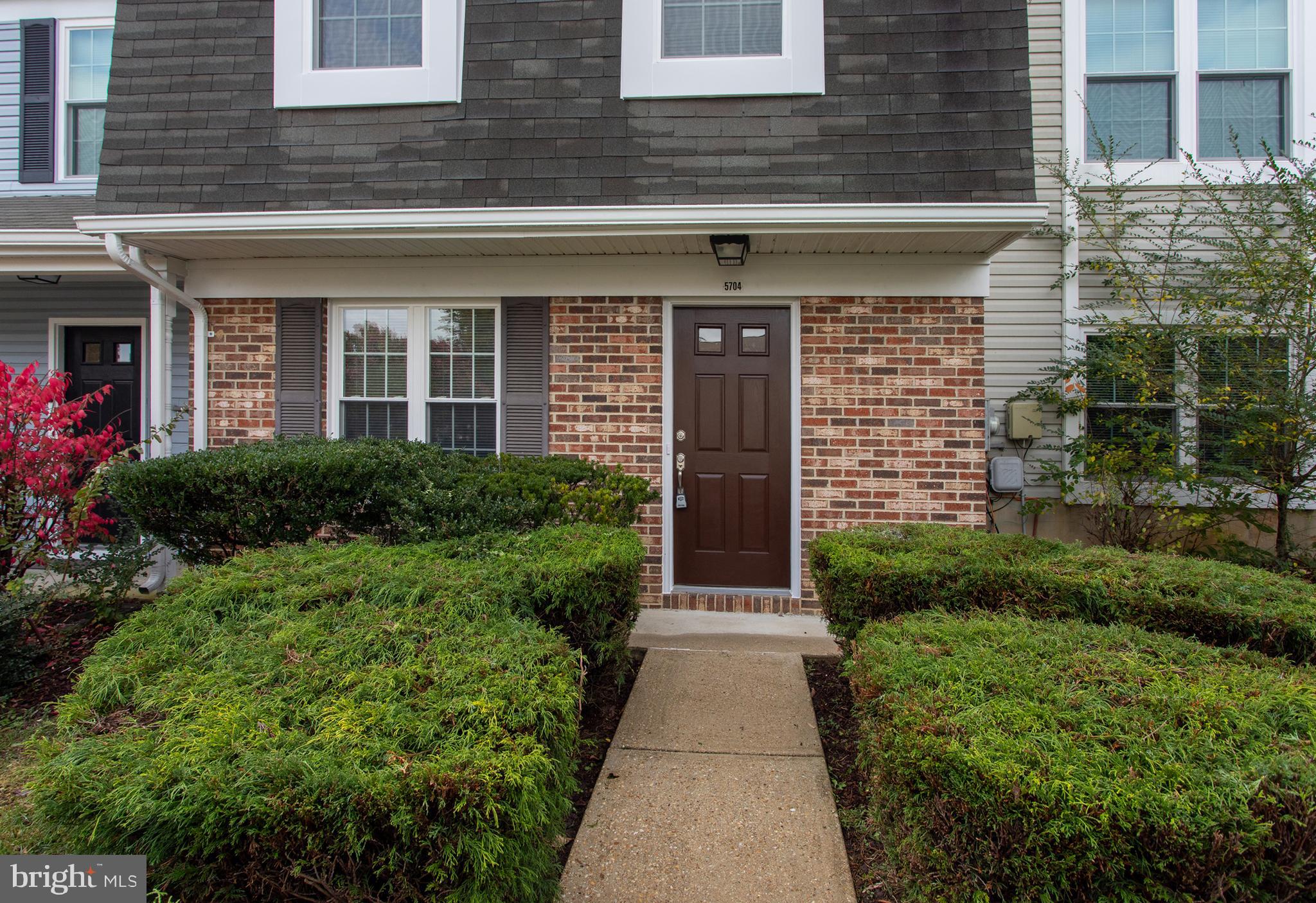 5704 Springfish Place Waldorf, MD 20603 - Photo 4 of 38 a view of brick house with a yard potted plants
