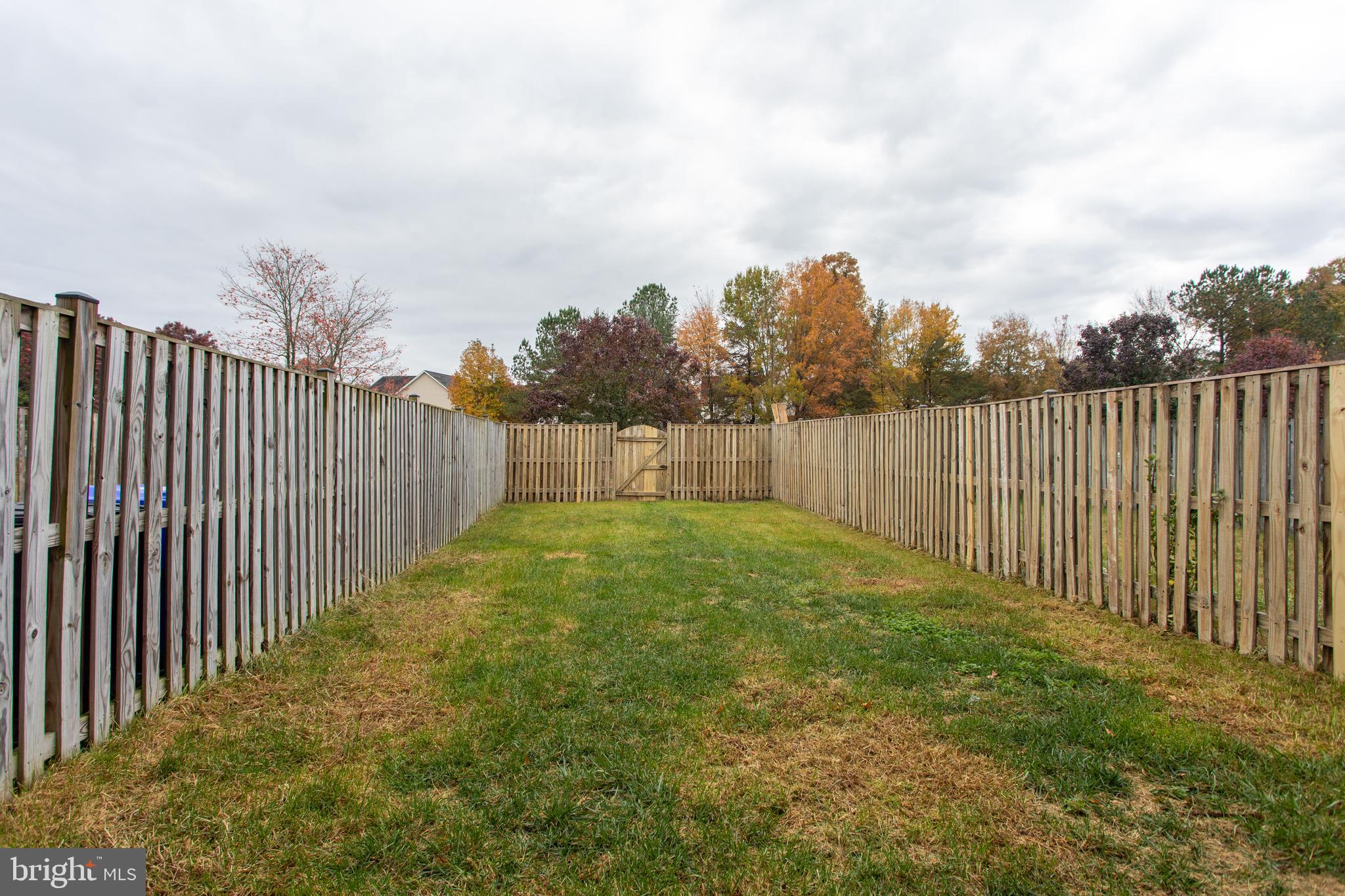 5704 Springfish Place Waldorf, MD 20603 - Photo 6 of 38 a view of a backyard with wooden fence