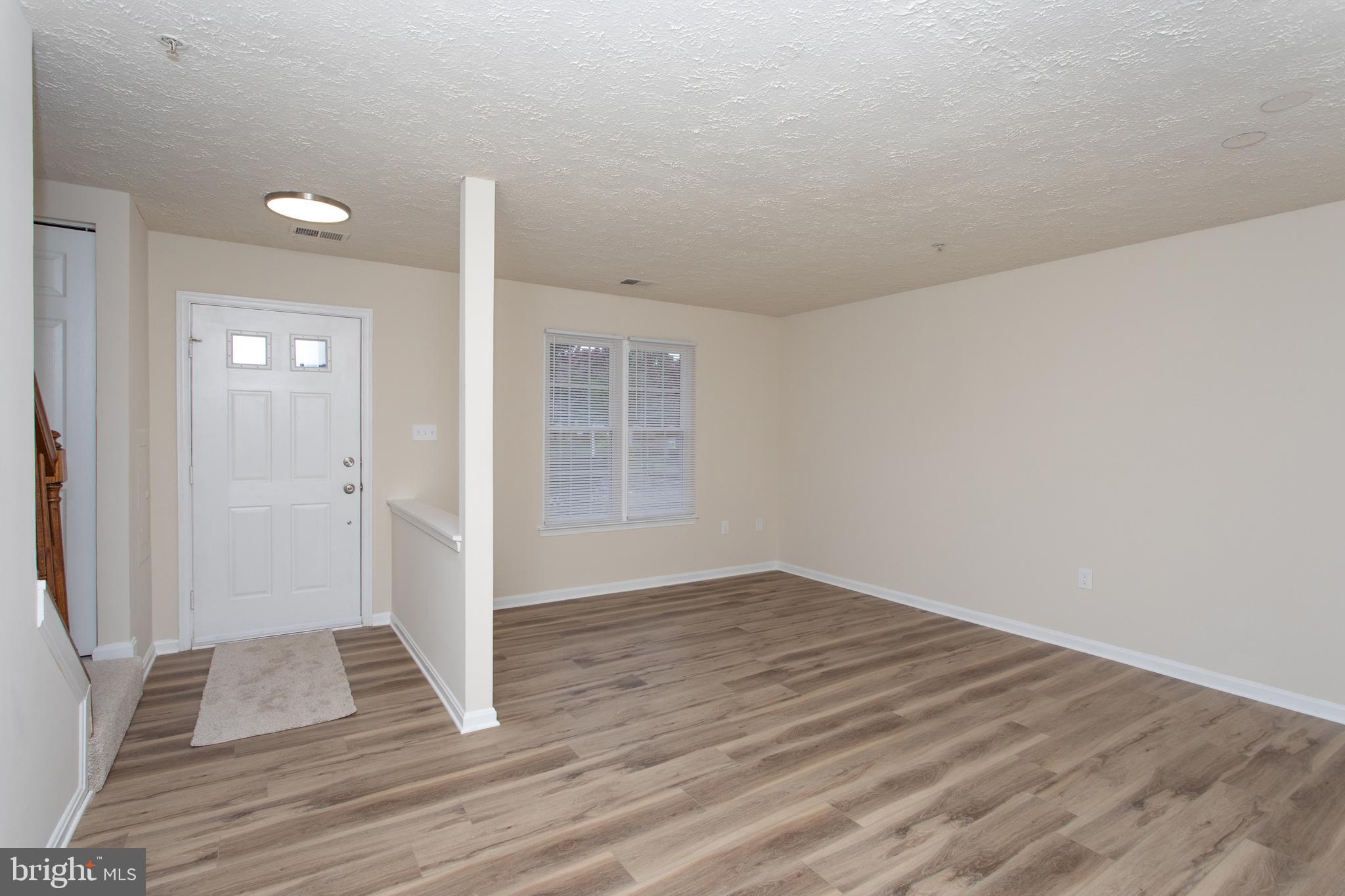 5704 Springfish Place Waldorf, MD 20603 - Photo 7 of 38 wooden floor in an empty room with a window