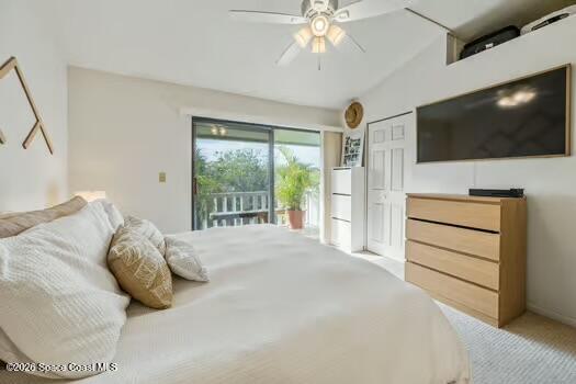 33 Cove Road Melbourne Beach, FL 32951 - Photo 15 of 34 a bedroom with a large bed a flat tv screen and a chandelier
