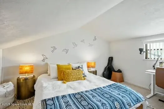 a bedroom with a bed window and a desk