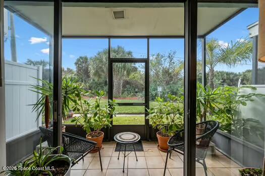 33 Cove Road Melbourne Beach, FL 32951 - Photo 5 of 34 a view of a porch with chairs and potted plants