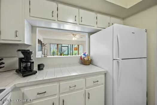 33 Cove Road Melbourne Beach, FL 32951 - Photo 9 of 34 a kitchen with appliances and cabinets