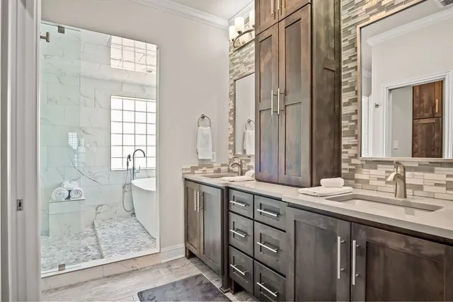 a bathroom with a double vanity sink mirror and shower
