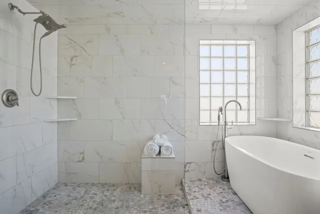 a bathroom with a bathtub sink and window
