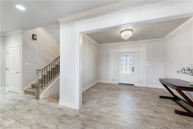 a view of a large room with wooden floor and windows