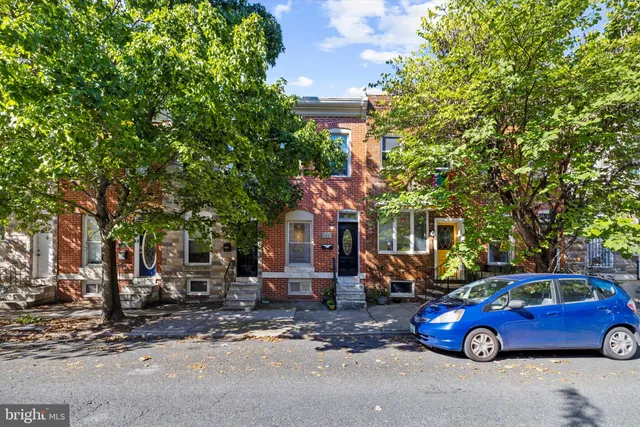 a front view of a house with parking space