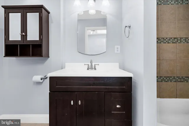 a bathroom with a sink and a mirror
