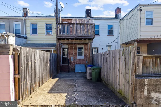 a view of a house with wooden fence