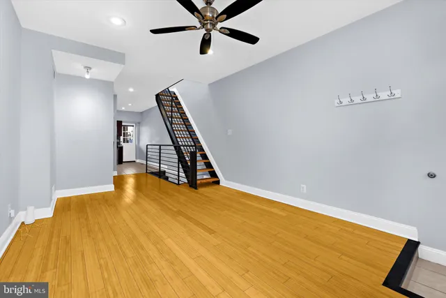 a view of an empty room with wooden floor
