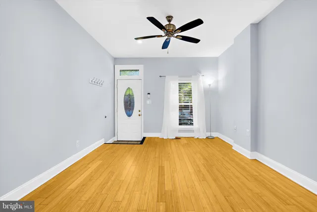 a big room with wooden floor and windows