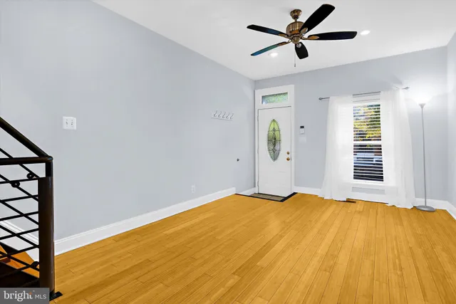 a view of a bedroom with wooden floor