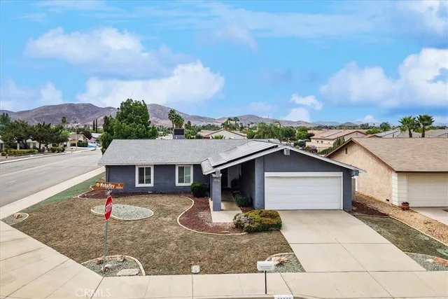 a aerial view of a house with swimming pool and a yard