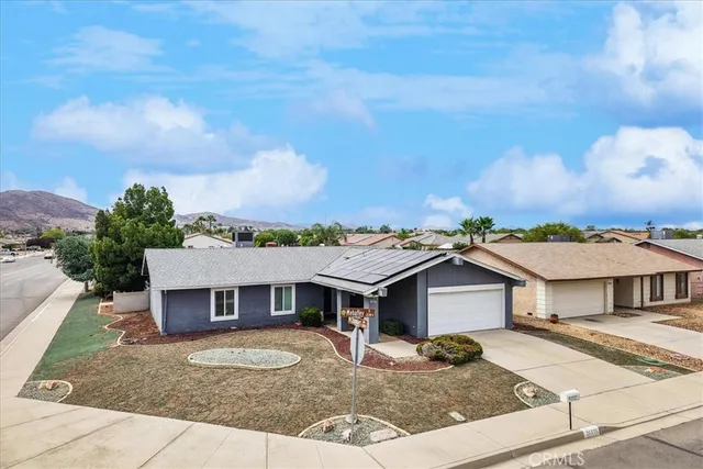 a aerial view of a house with a yard and table and chairs