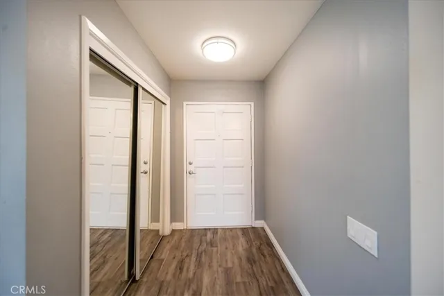 a view of a room with wooden floor closet and windows