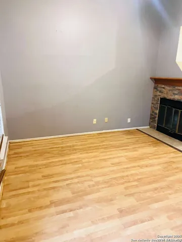 a bathroom with a granite countertop sink a mirror and shower