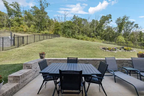 a view of a patio with table and chairs and potted plants