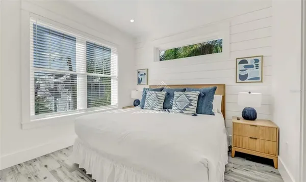 a large white bed in a white room