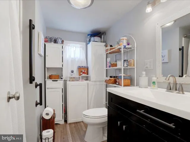 a bathroom with a sink vanity mirror and toilet