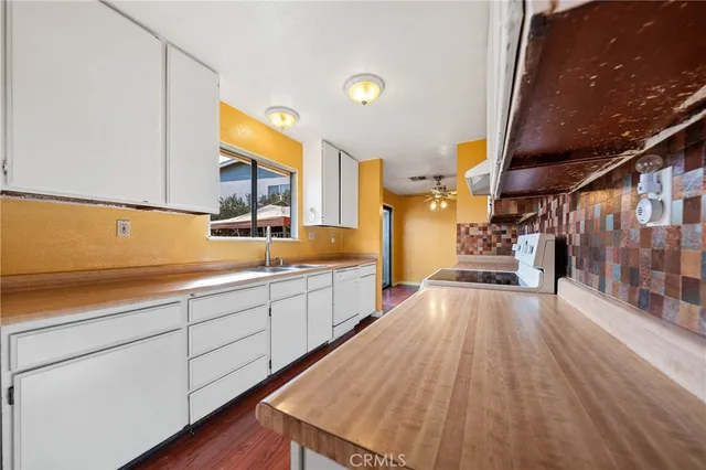 a view of a kitchen with a sink and cabinets