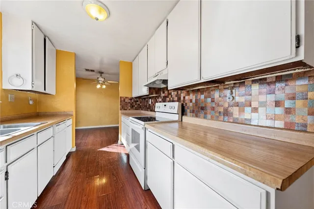 a kitchen with stainless steel appliances granite countertop a sink and cabinets