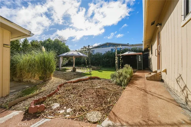 a view of a house with backyard and sitting area