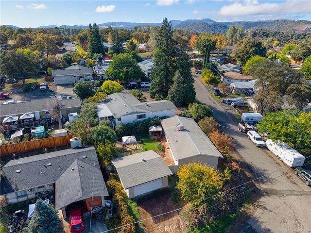 an aerial view of a houses with a city street