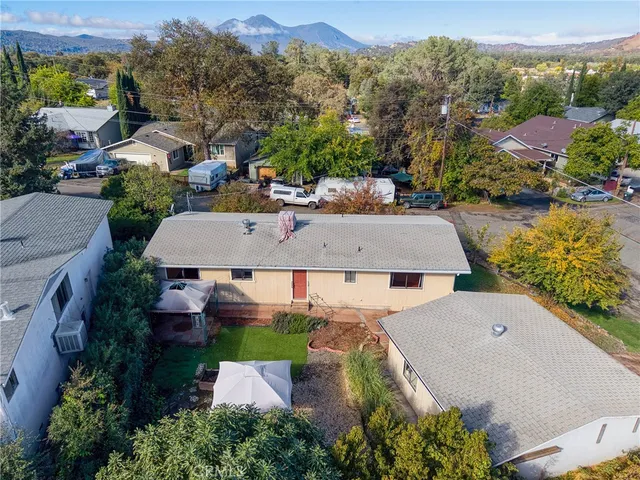 an aerial view of multiple houses with yard