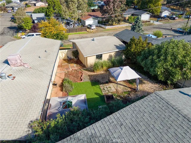 an aerial view of a house with a yard and trees
