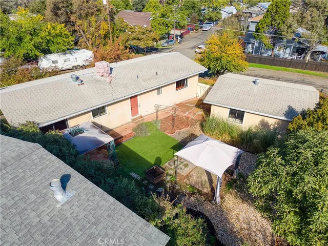 an aerial view of a house with a garden and swimming pool
