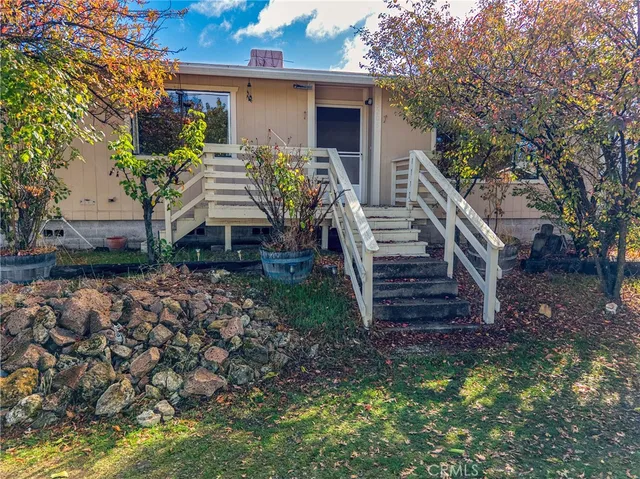 a front view of a house with plants