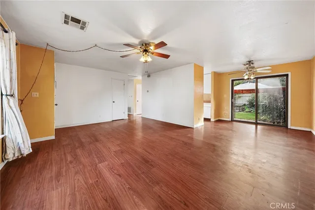 a view of an empty room with glass door