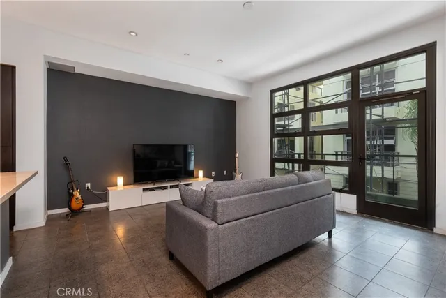 a living room with furniture and large window