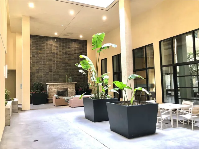 a living room with furniture potted plant and a wooden floor