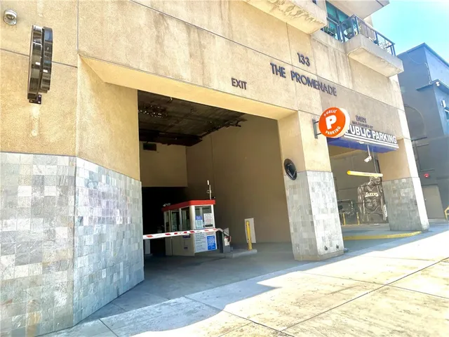 a view of a hallway with wooden floor and a potted plant