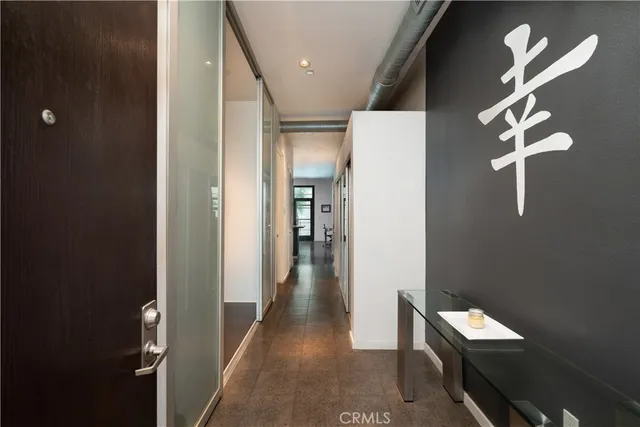 a kitchen with stainless steel appliances a table and chairs in it