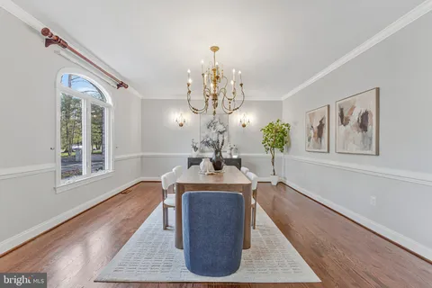 a large kitchen with stainless steel appliances granite countertop a lot of counter space and wooden floors