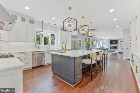 a dining room with wooden floor and a chandelier