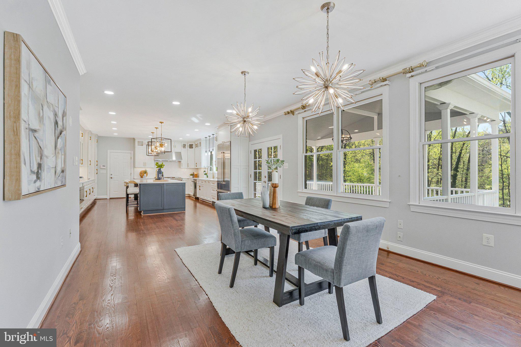8611 Brook Road McLean, VA 22102 - Photo 28 of 104 a dining room with furniture a chandelier and wooden floor