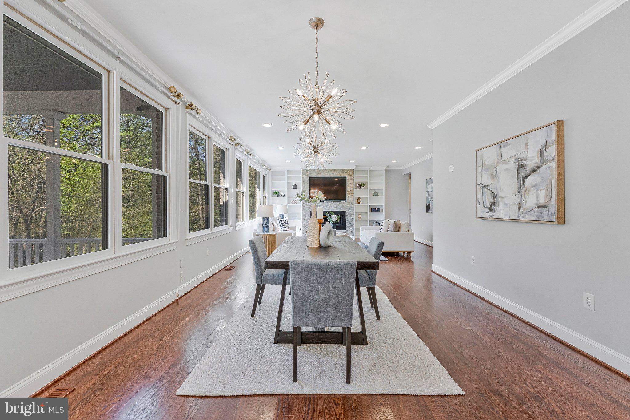 8611 Brook Road McLean, VA 22102 - Photo 30 of 104 a dining room with wooden floor and a chandelier