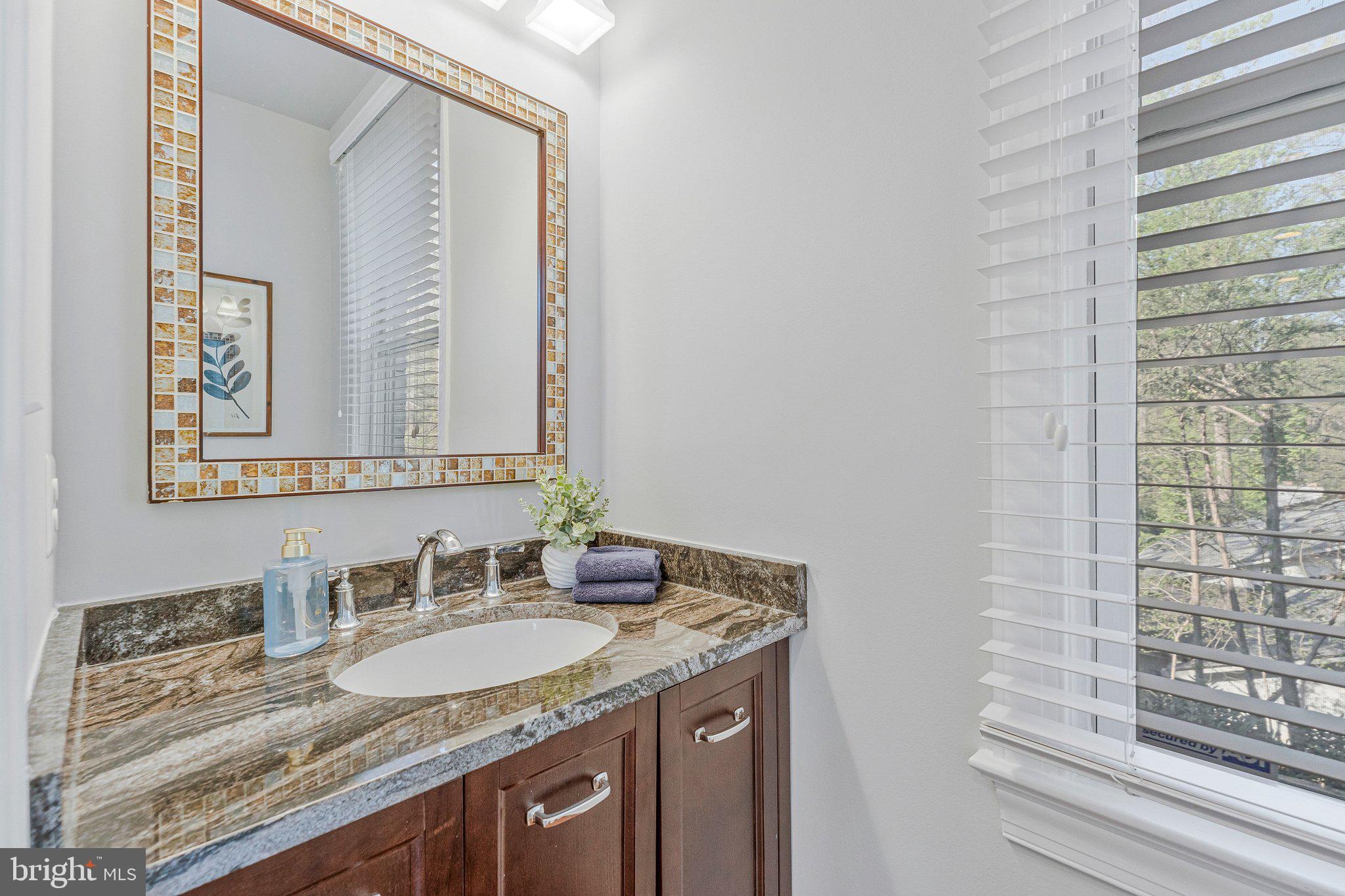 8611 Brook Road McLean, VA 22102 - Photo 42 of 104 a bathroom with a granite countertop sink and a mirror