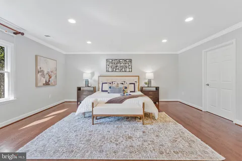 a hall with wooden floor and a fireplace